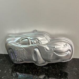 Wilton Lightning McQueen race car world of cars.  Cake tin.